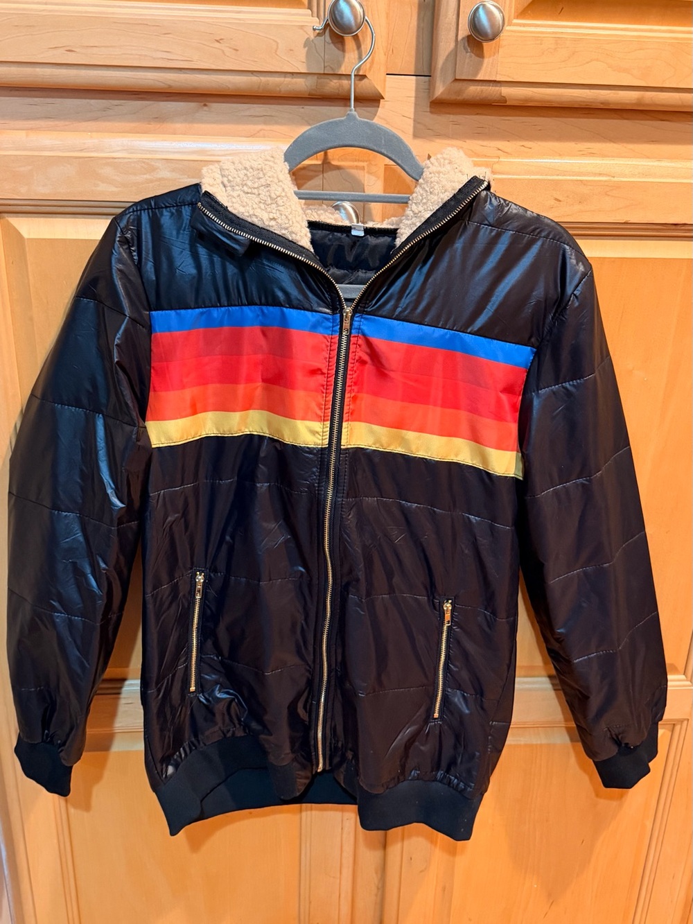 NWOT Black Hooded Puffer Jacket with Blue, Red and Yellow Stripes